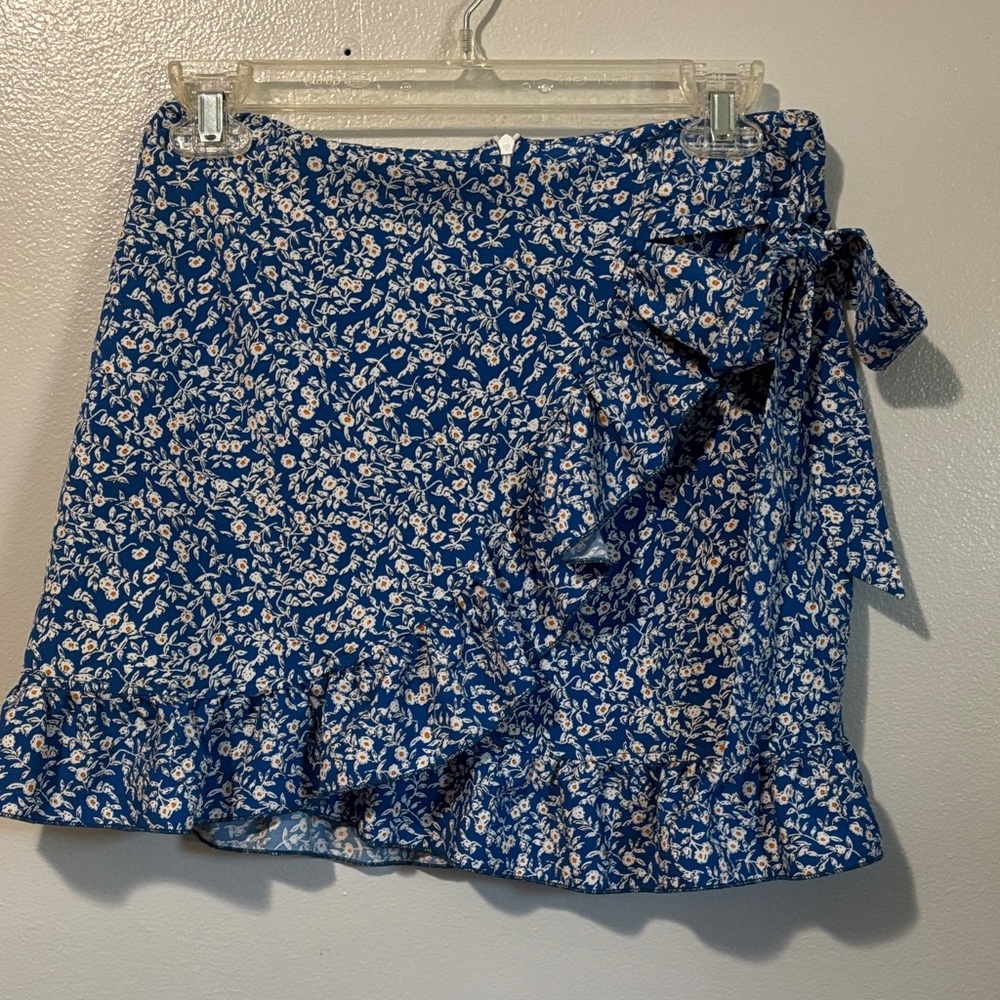 Floral Blue ruffle Skirt with bow tie on left hip and zipper in the back.